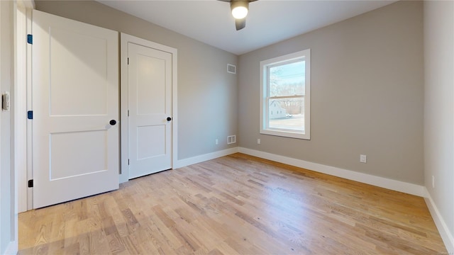 unfurnished bedroom with ceiling fan and light wood-type flooring