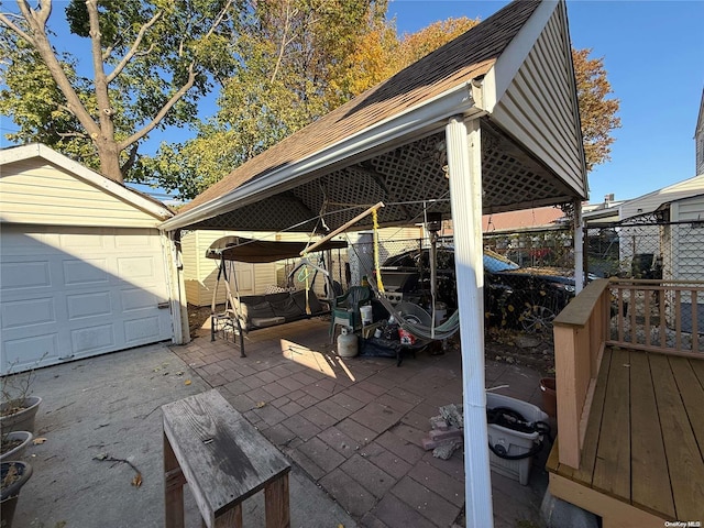 view of patio featuring an outdoor structure and a garage