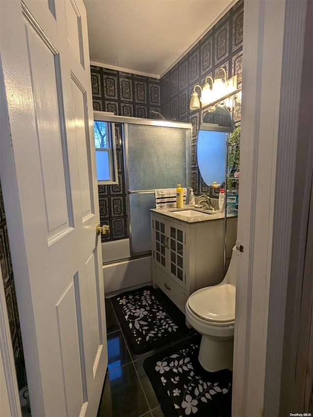 full bathroom with tile patterned flooring, vanity, toilet, and shower / bath combination with glass door