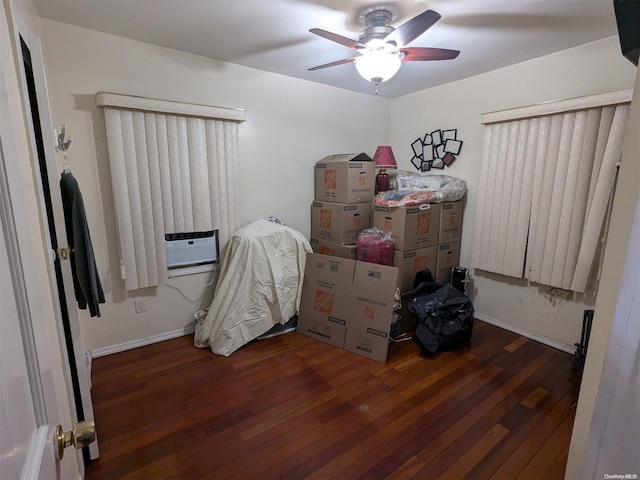 bedroom featuring cooling unit, ceiling fan, and dark wood-type flooring