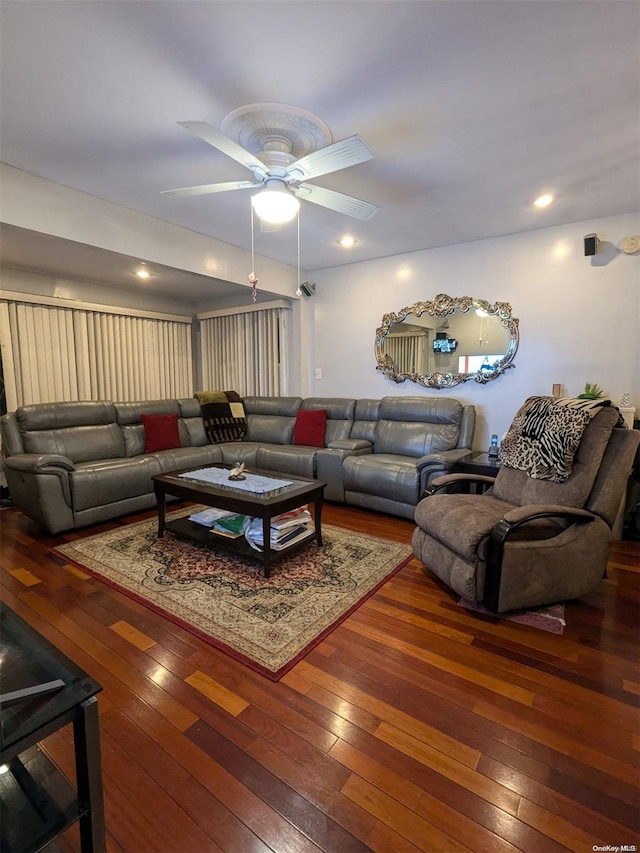 living room with dark hardwood / wood-style floors and ceiling fan