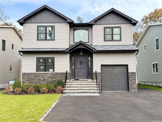 craftsman inspired home featuring a front lawn and a garage