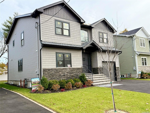 view of front of property with a garage and a front lawn