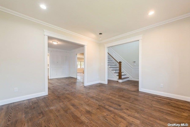 spare room featuring ornamental molding and dark wood-type flooring