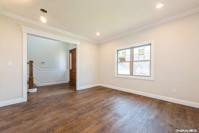 empty room featuring crown molding and dark wood-type flooring