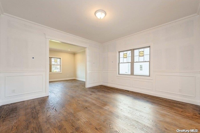 empty room featuring hardwood / wood-style floors and ornamental molding