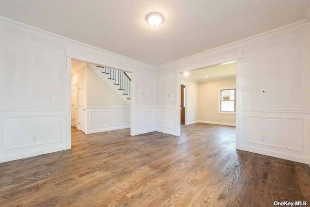 unfurnished room featuring hardwood / wood-style flooring and ornamental molding