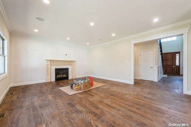 unfurnished living room featuring dark hardwood / wood-style flooring and ornamental molding