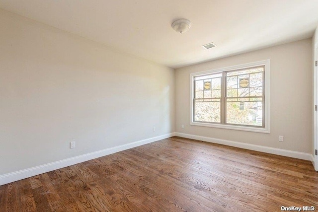 empty room with wood-type flooring