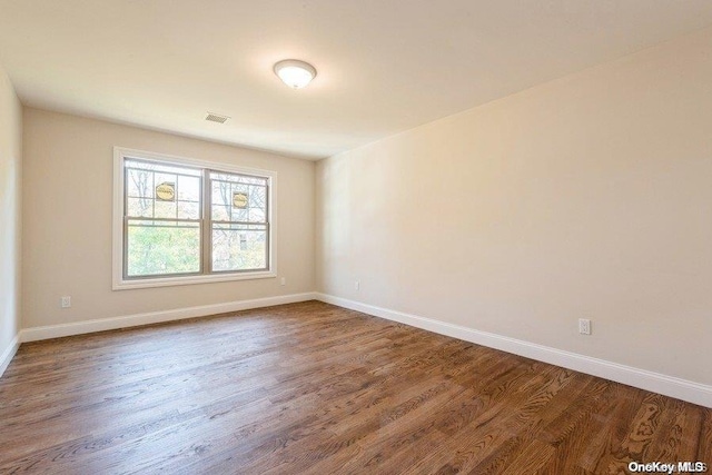 unfurnished room featuring hardwood / wood-style flooring