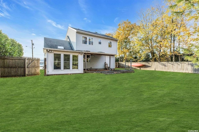 rear view of property with a yard