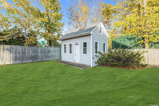 view of outbuilding featuring a yard