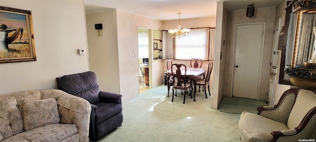 living room with carpet and a notable chandelier