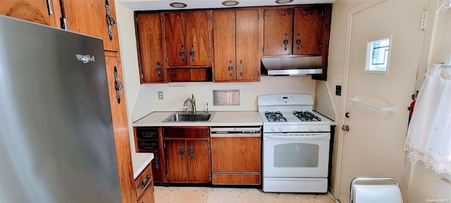 kitchen with stainless steel refrigerator, dishwasher, white range with gas cooktop, and sink