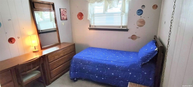 bedroom featuring wood walls