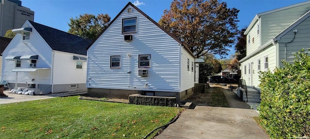 view of side of property with a lawn