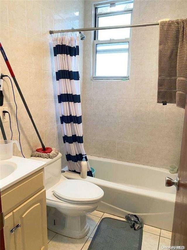 full bathroom featuring tile patterned floors, shower / tub combo with curtain, vanity, and toilet