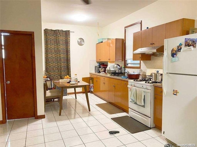 kitchen with light tile patterned floors and white appliances