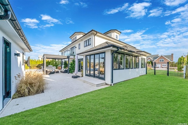 rear view of house featuring a patio area and a yard