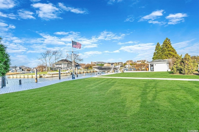 view of yard with a water view and a dock