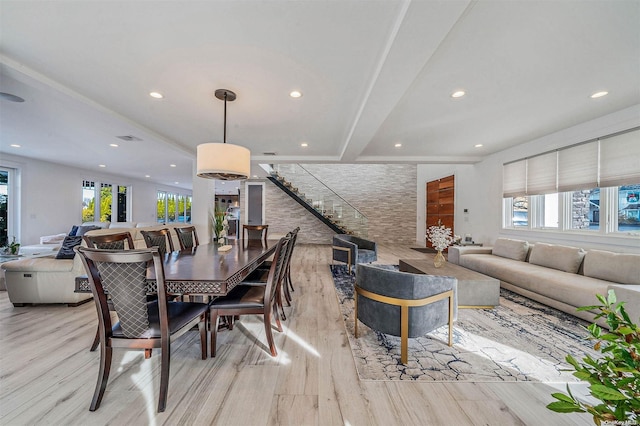 dining area with a healthy amount of sunlight and light hardwood / wood-style flooring