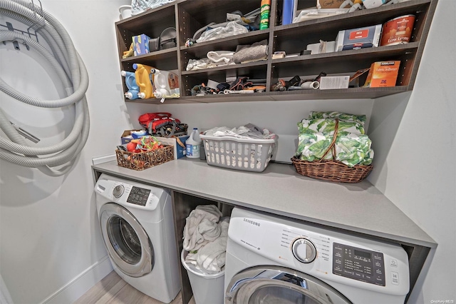 clothes washing area featuring hardwood / wood-style floors and washing machine and clothes dryer