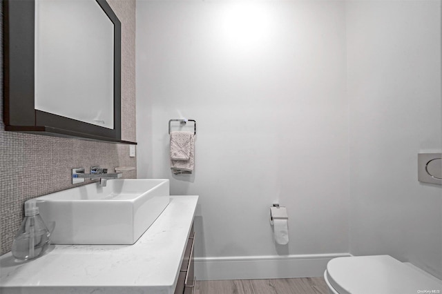 bathroom featuring hardwood / wood-style floors, vanity, and toilet