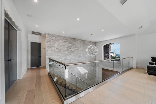 hallway with light hardwood / wood-style floors