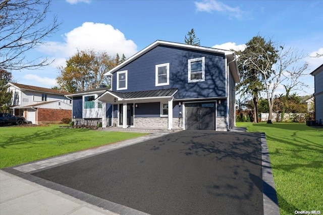 view of front of home with covered porch, a garage, and a front lawn