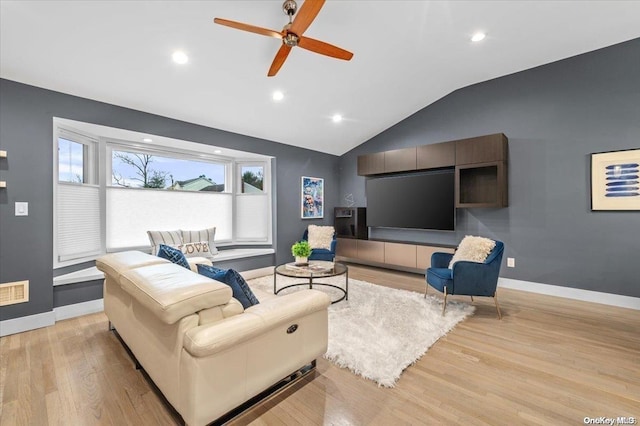 living room featuring ceiling fan, light wood-type flooring, and lofted ceiling