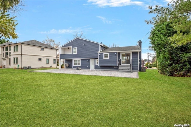 back of property featuring a lawn and a patio area