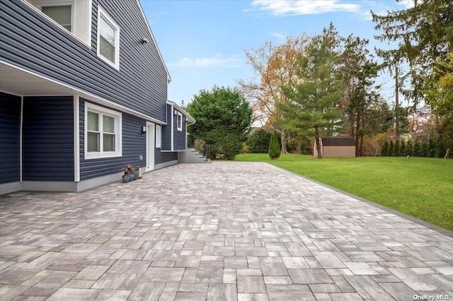 view of patio / terrace featuring a storage shed