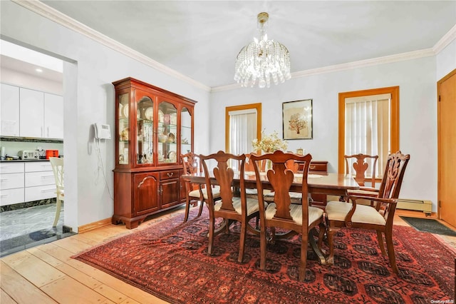 dining space with a chandelier, a baseboard radiator, light hardwood / wood-style flooring, and crown molding