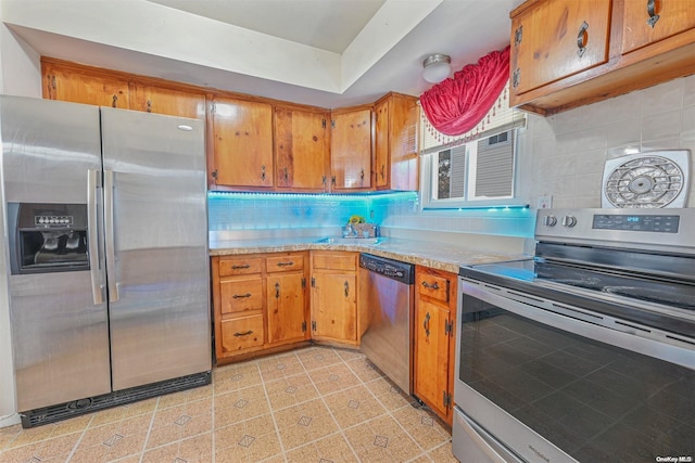 kitchen featuring backsplash, sink, and stainless steel appliances