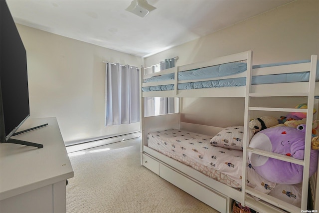 bedroom with baseboard heating and carpet