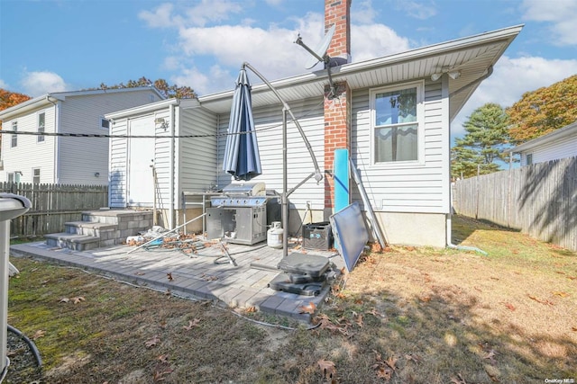 back of house with a patio area and a yard