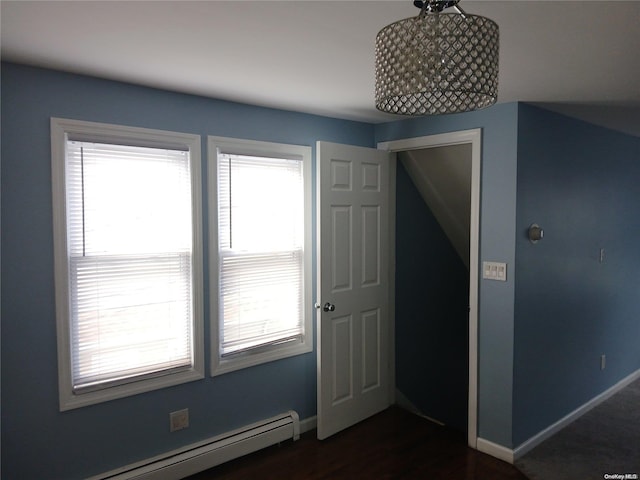 interior space featuring a baseboard radiator, plenty of natural light, and dark hardwood / wood-style floors