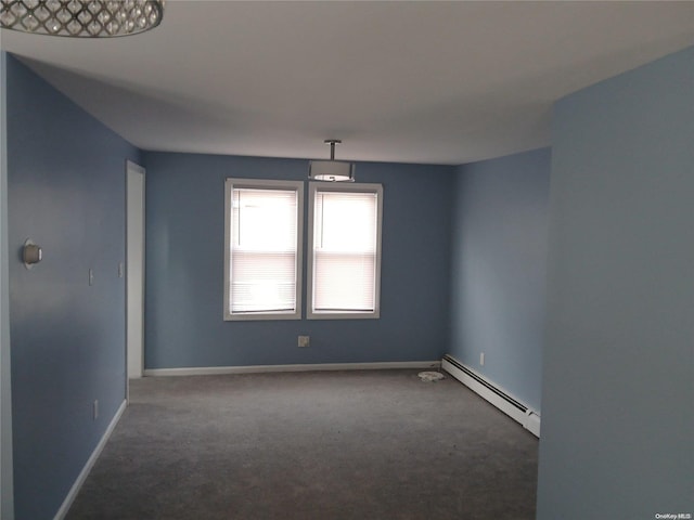 carpeted empty room featuring a baseboard radiator