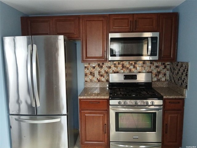 kitchen featuring stone counters, decorative backsplash, and appliances with stainless steel finishes