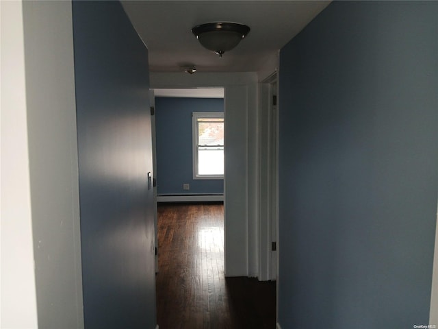 corridor with dark wood-type flooring and a baseboard radiator