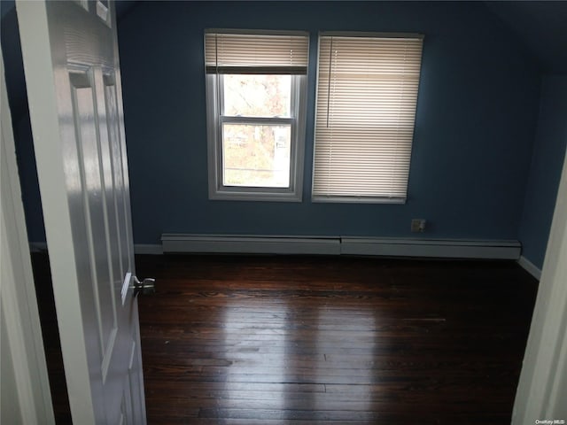 unfurnished room with dark hardwood / wood-style flooring and lofted ceiling