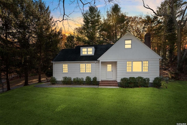 new england style home with a yard