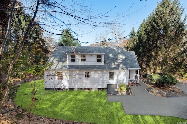 rear view of property with a yard