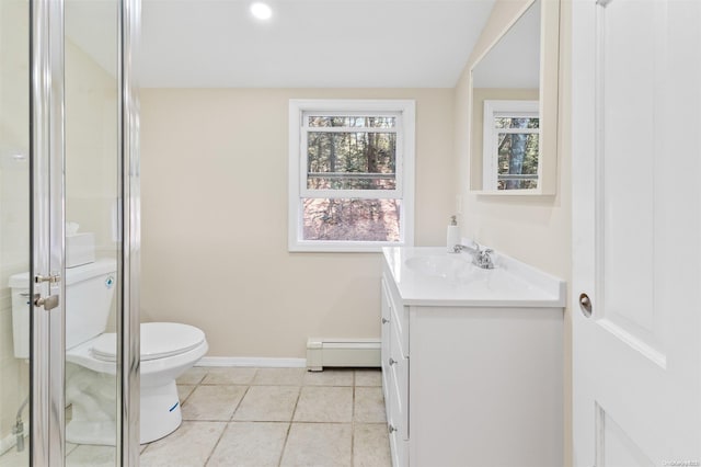 bathroom featuring vanity, tile patterned floors, toilet, baseboard heating, and a shower with shower door