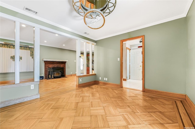 unfurnished living room with ornamental molding, a wood stove, and light parquet floors