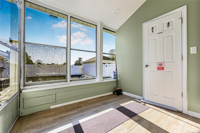 unfurnished sunroom with vaulted ceiling