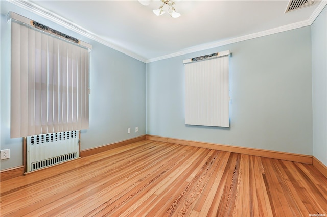 unfurnished room with radiator heating unit, crown molding, and hardwood / wood-style floors