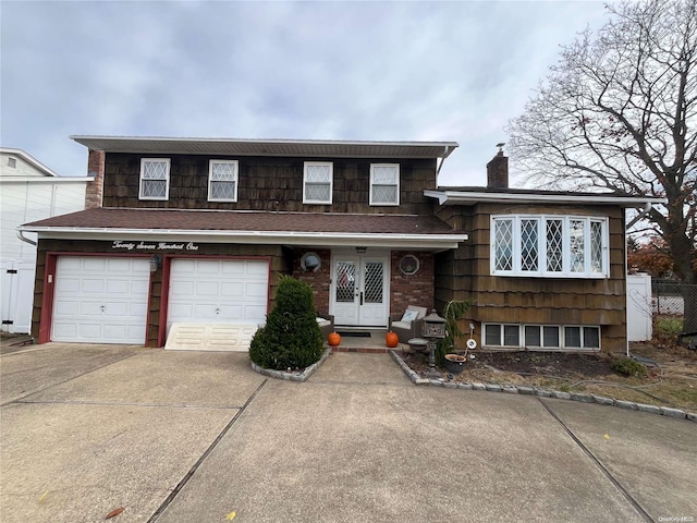 tri-level home with french doors and a garage