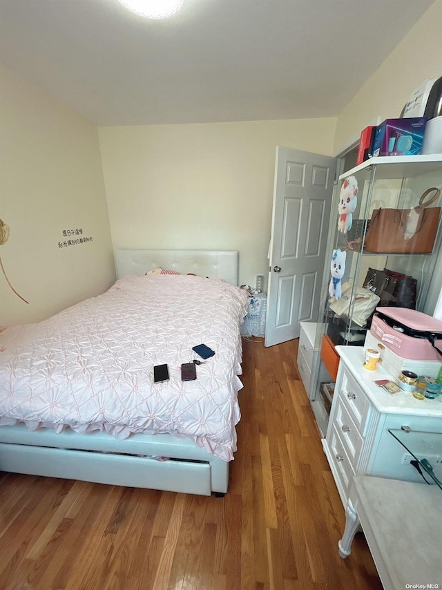 bedroom with hardwood / wood-style floors