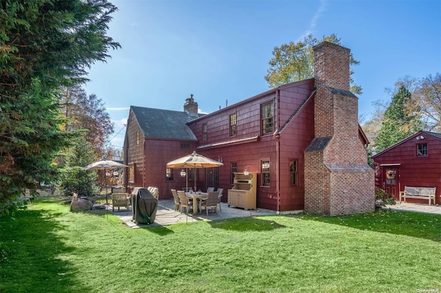 back of property featuring a patio and a lawn